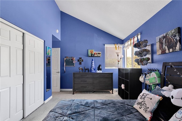 carpeted bedroom featuring lofted ceiling, a closet, and a textured ceiling