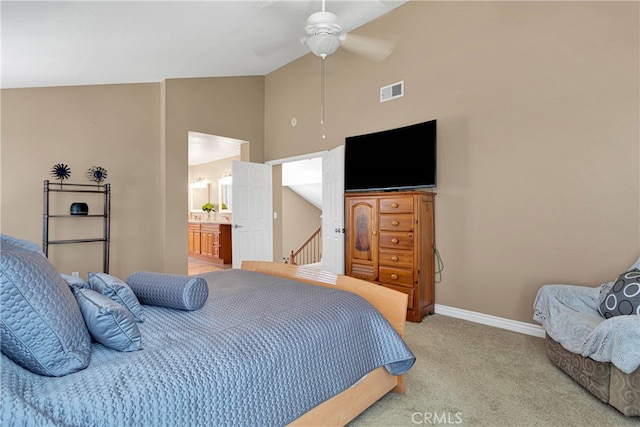 carpeted bedroom featuring high vaulted ceiling, ensuite bath, and ceiling fan