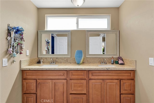 bathroom featuring a healthy amount of sunlight and vanity