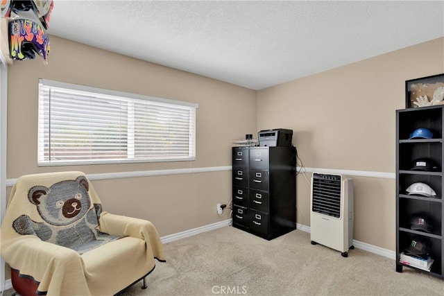 living area featuring a textured ceiling, a healthy amount of sunlight, and light colored carpet