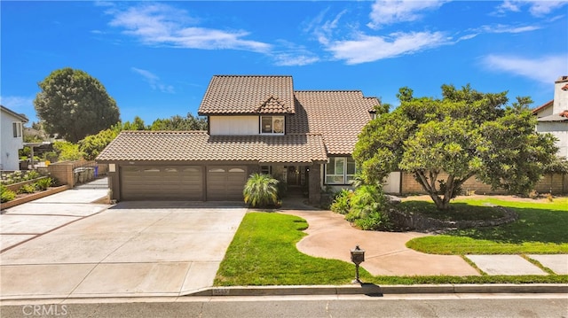 mediterranean / spanish home with a front yard and a garage