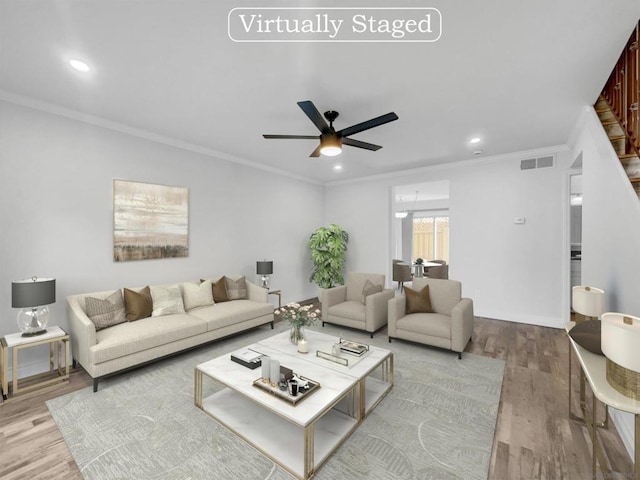 living room with ceiling fan, light hardwood / wood-style flooring, and crown molding