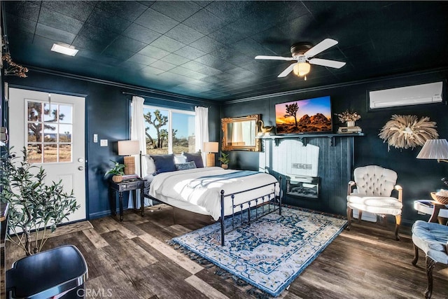 bedroom with ornamental molding, an AC wall unit, ceiling fan, and hardwood / wood-style flooring