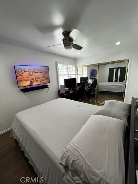 bedroom featuring ceiling fan and dark wood-type flooring