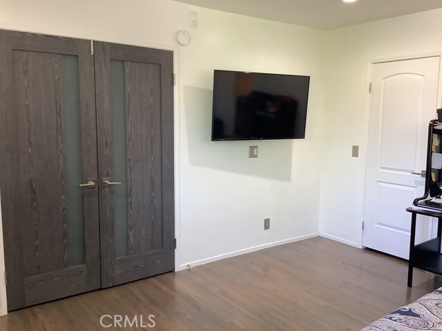 bedroom with wood-type flooring