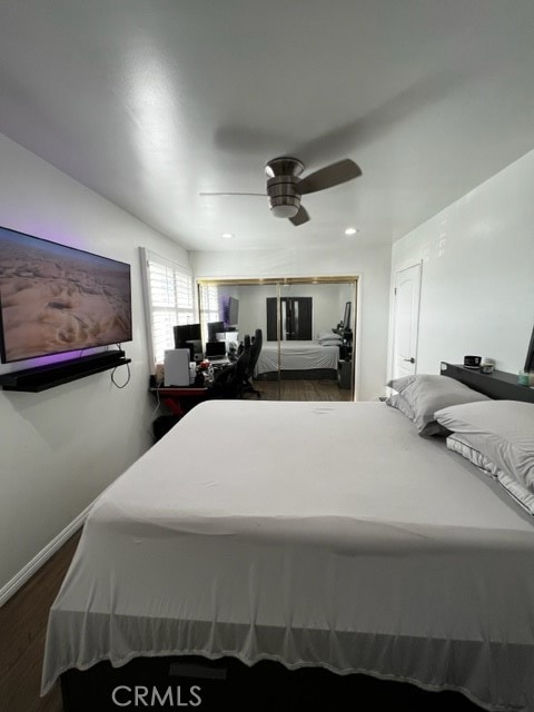 bedroom with ceiling fan and dark hardwood / wood-style flooring