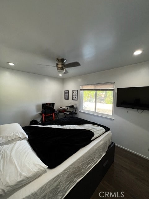 bedroom with dark wood-type flooring and ceiling fan