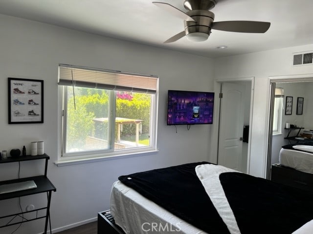 bedroom with ceiling fan and hardwood / wood-style flooring