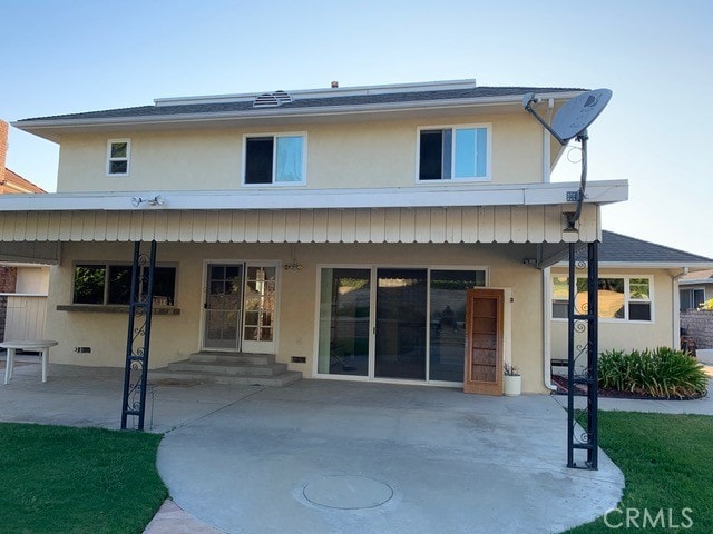 rear view of property featuring a patio