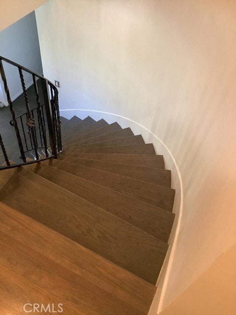 stairs featuring wood-type flooring