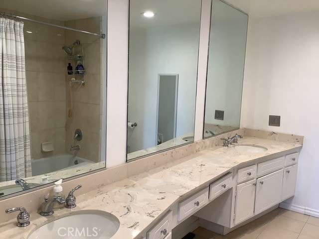 bathroom with tile patterned flooring, shower / bath combo, and vanity