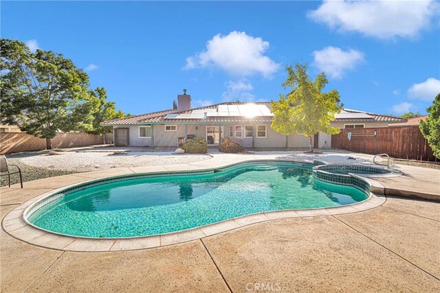 view of swimming pool featuring an in ground hot tub and a patio