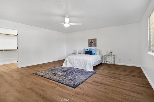 bedroom with ceiling fan and wood-type flooring