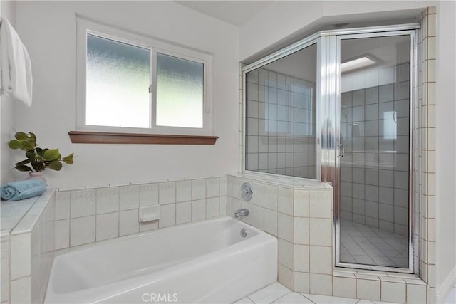 bathroom with tile patterned flooring and shower with separate bathtub