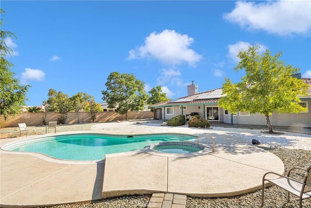 view of pool featuring a patio area and an in ground hot tub