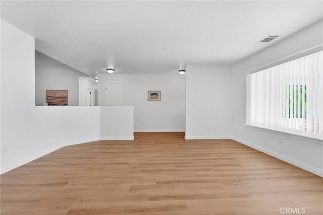 spare room featuring light hardwood / wood-style flooring