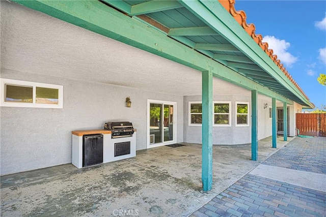 view of patio / terrace featuring a grill and exterior kitchen