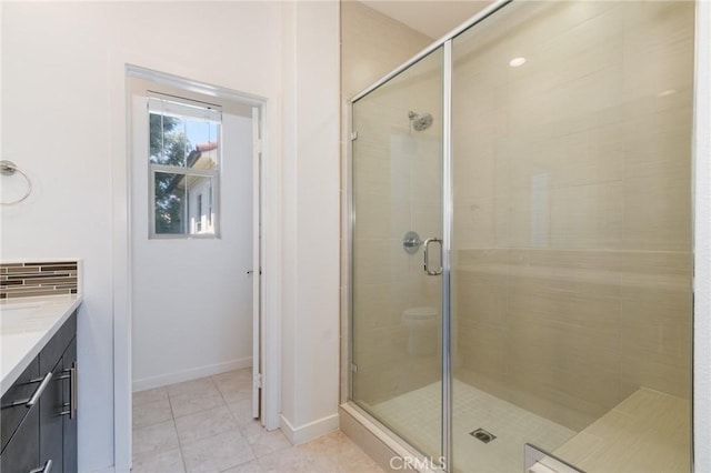 bathroom featuring tile patterned floors, vanity, and an enclosed shower