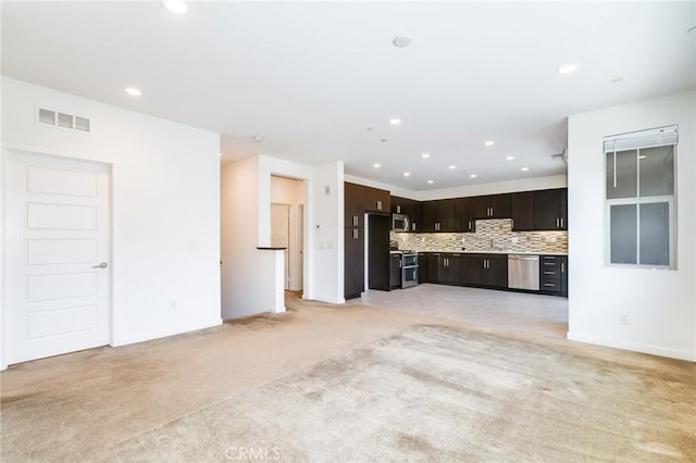 unfurnished living room with light colored carpet