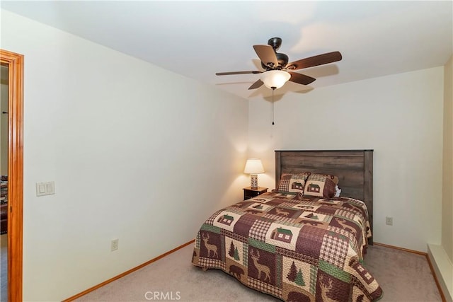 bedroom with ceiling fan and light carpet