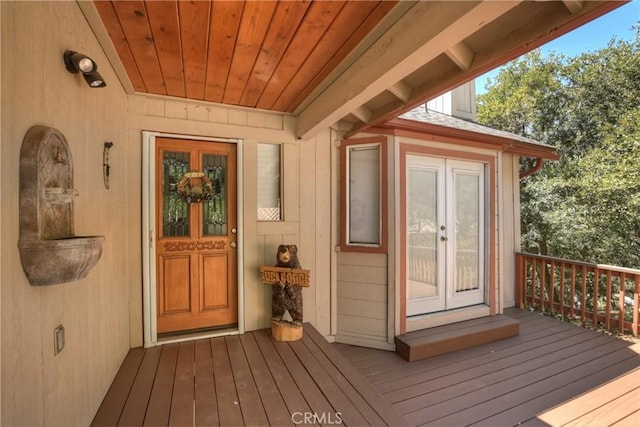 entrance to property featuring a deck and french doors