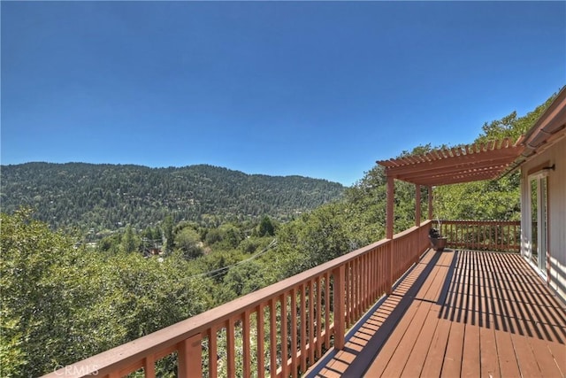 wooden terrace with a mountain view and a pergola