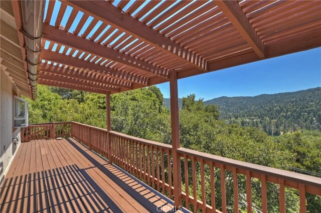 wooden deck with a mountain view and a pergola