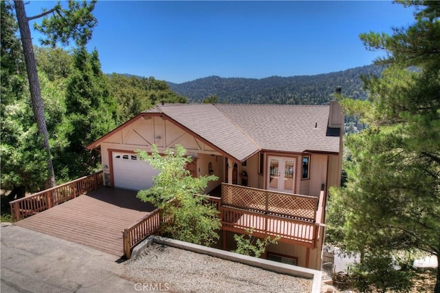 view of front facade with french doors and a deck with mountain view