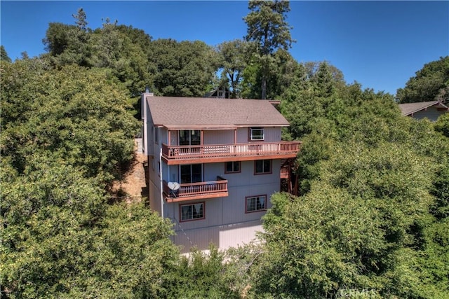 back of property featuring a balcony