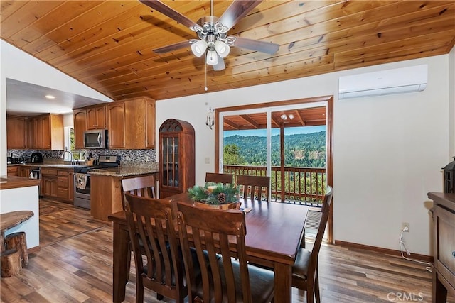 dining space with an AC wall unit, wooden ceiling, dark wood-type flooring, and vaulted ceiling