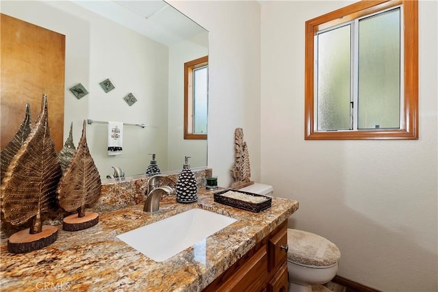 bathroom featuring vanity and toilet