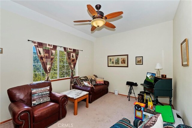 living area featuring carpet floors and ceiling fan