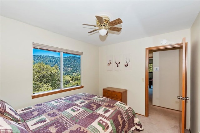 bedroom featuring ceiling fan and light colored carpet