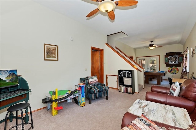 carpeted living room featuring french doors and ceiling fan