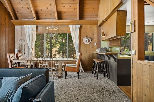 interior space with wood ceiling, wood walls, beamed ceiling, and carpet floors