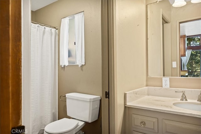 bathroom with vanity, toilet, and a shower with curtain