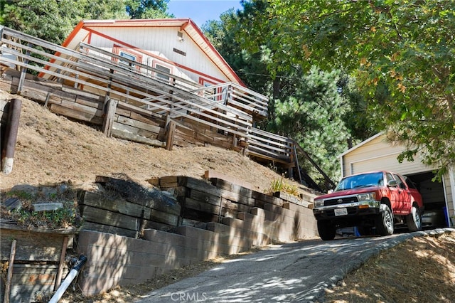 view of home's exterior with a garage and an outbuilding