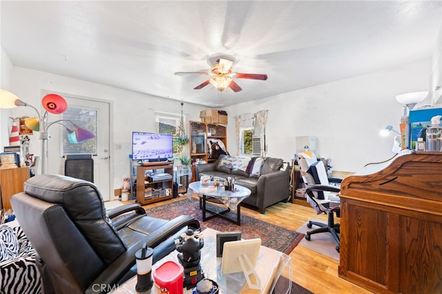 living room featuring light hardwood / wood-style floors and ceiling fan