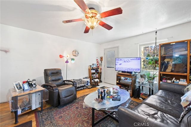 living room featuring wood-type flooring and ceiling fan