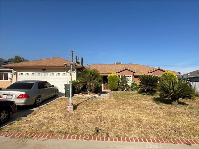 ranch-style house featuring a front lawn and a garage