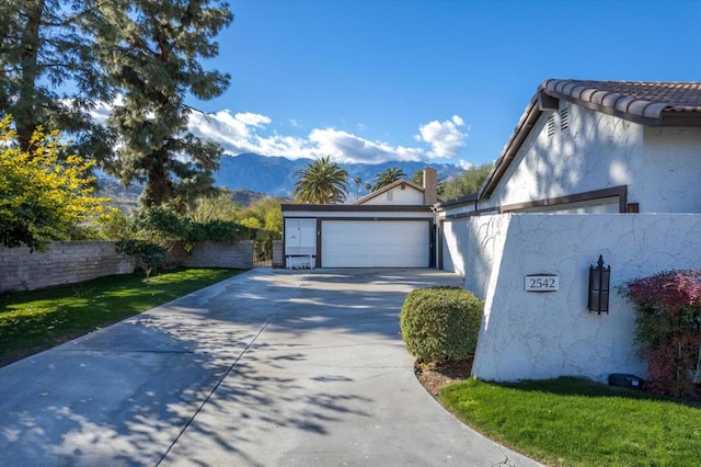 view of side of property with a mountain view and a garage