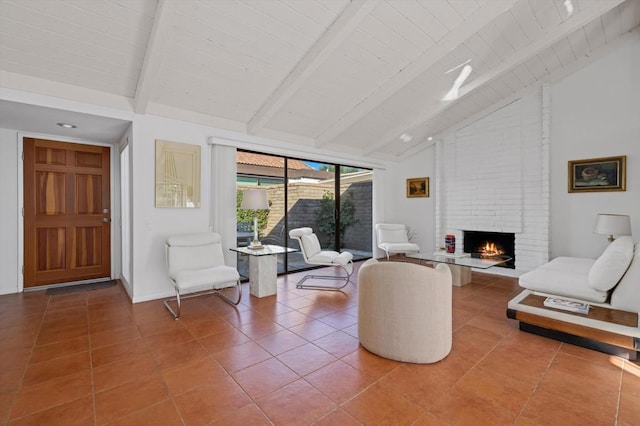 tiled living room featuring beam ceiling, high vaulted ceiling, and a brick fireplace