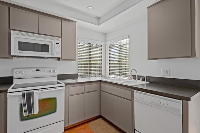 kitchen featuring gray cabinets, white appliances, and sink