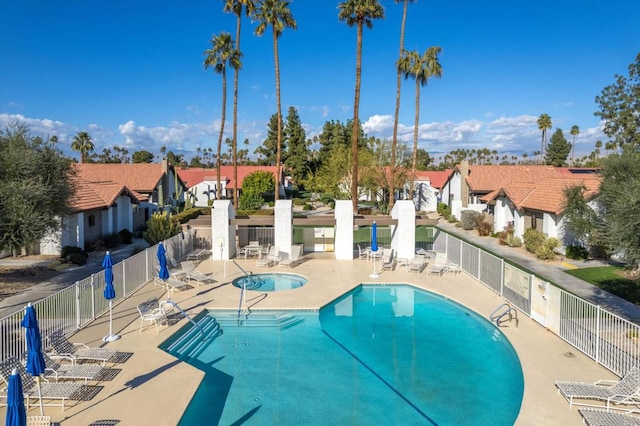 view of swimming pool with a patio and a community hot tub