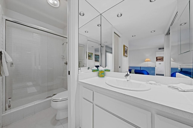 bathroom with tile patterned flooring, vanity, toilet, and an enclosed shower