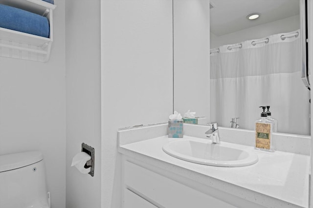 bathroom with vanity, toilet, and a shower with shower curtain