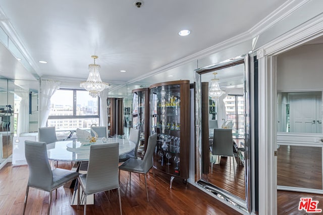 dining area with a chandelier, crown molding, and hardwood / wood-style flooring