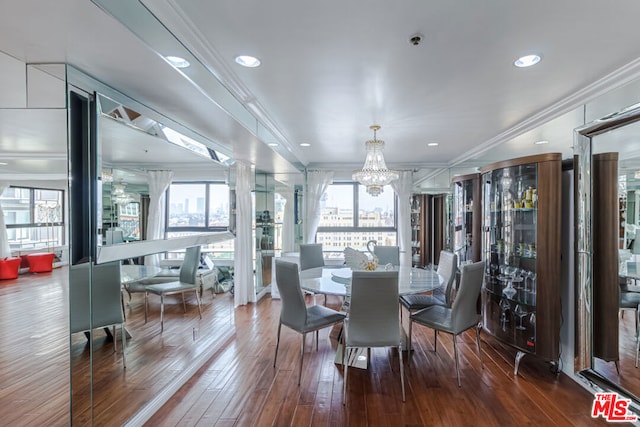 dining area with crown molding, dark hardwood / wood-style flooring, and a healthy amount of sunlight