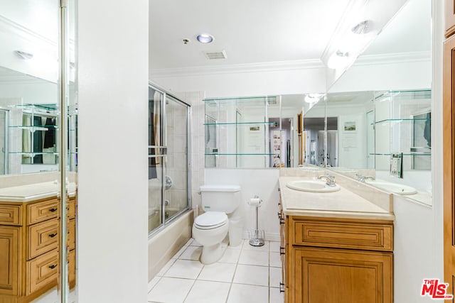 full bathroom with shower / bath combination with glass door, vanity, tile patterned floors, crown molding, and toilet