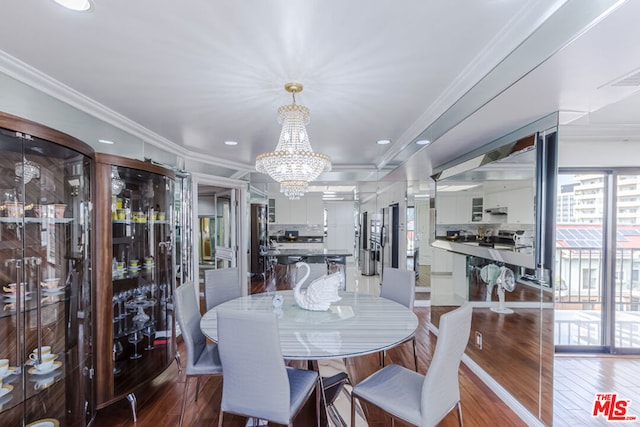 dining area featuring ornamental molding, hardwood / wood-style flooring, and a chandelier